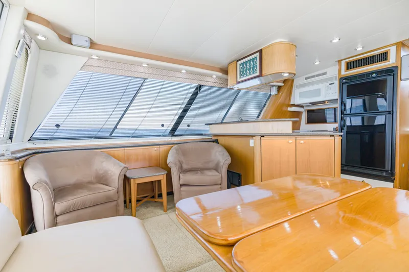 Slide: The Image of Luxurious interior of 1997 Bayliner 4788 Pilot House Motoryacht with modern kitchen and seating area. - 18
