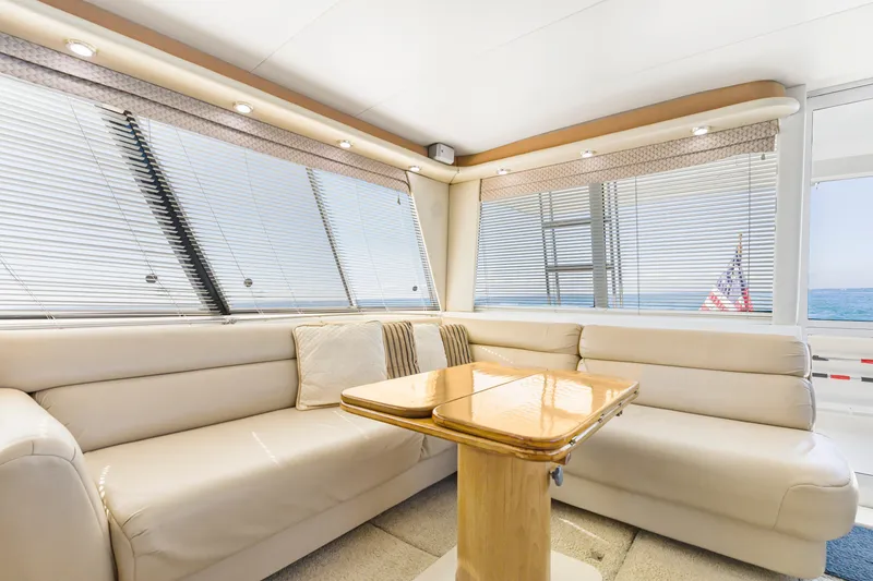 Slide: The Image of Luxurious interior of 1997 Bayliner 4788 Pilot House Motoryacht with plush seating and wooden table. - 20