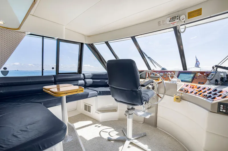 Slide: The Image of Interior of 1997 Bayliner 4788 Pilot House Motoryacht with helm and seating area. - 21