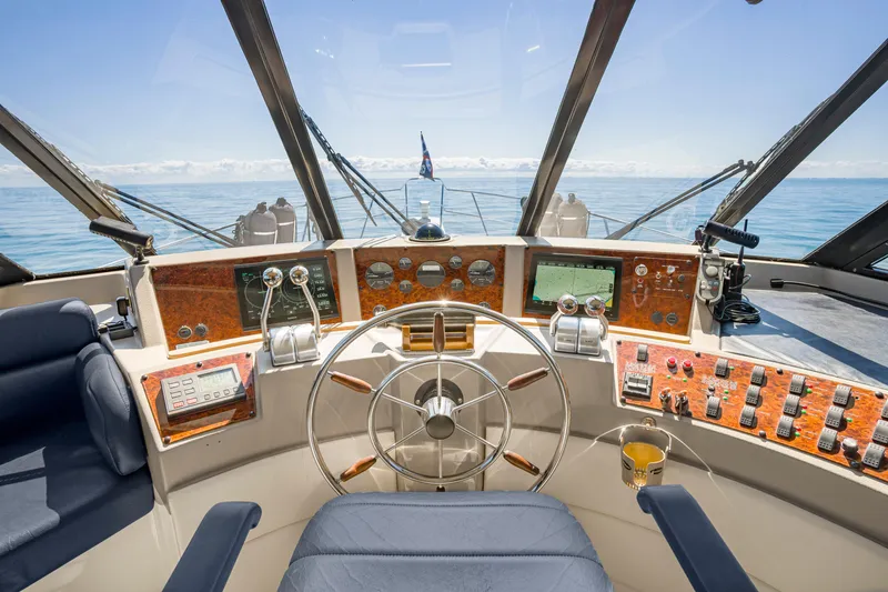 Slide: The Image of Cockpit of 1997 Bayliner 4788 Pilot House Motoryacht with ocean view and navigation controls. - 22
