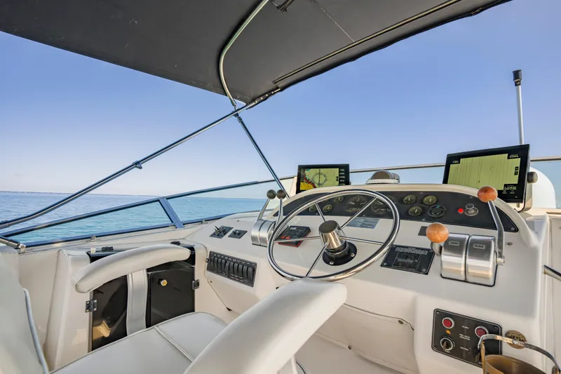 Slide: The Image of 1997 Bayliner 4788 Pilot House Motoryacht helm with navigation screens and controls. - 27