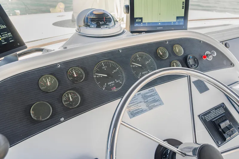 Slide: The Image of 1997 Bayliner 4788 Pilot House Motoryacht dashboard with gauges and steering wheel. - 29