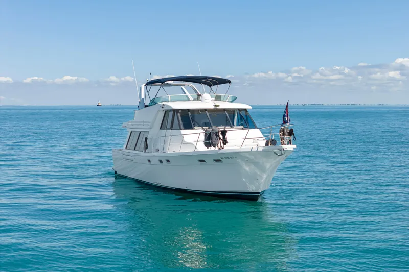 Slide: The Image of 1997 Bayliner 4788 Pilot House Motoryacht cruising on clear blue waters. - 3