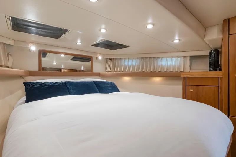 Slide: The Image of Luxurious bedroom interior of 1997 Bayliner 4788 Pilot House Motoryacht with cozy bedding. - 34