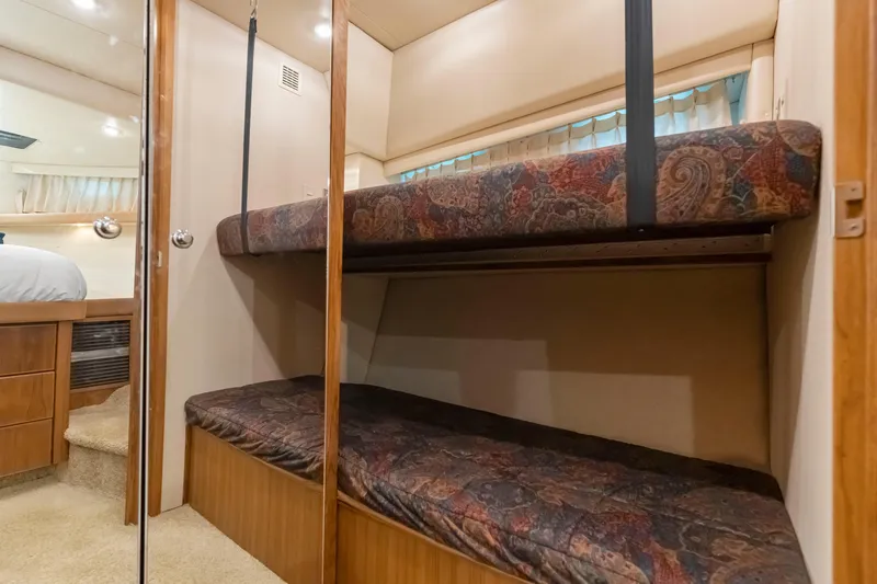 Slide: The Image of Interior of 1997 Bayliner 4788 Pilot House Motoryacht with bunk beds and wood finish. - 37
