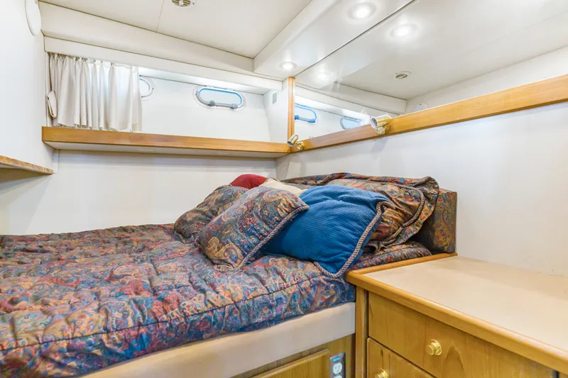 Slide: The Image of Cozy bedroom in 1997 Bayliner 4788 Pilot House Motoryacht with colorful bedding and wood accents. - 39