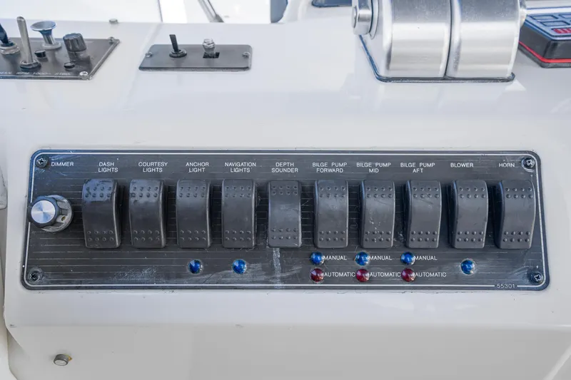 Slide: The Image of Control panel of a 1997 Bayliner 4788 Pilot House Motoryacht with various switches. - 42