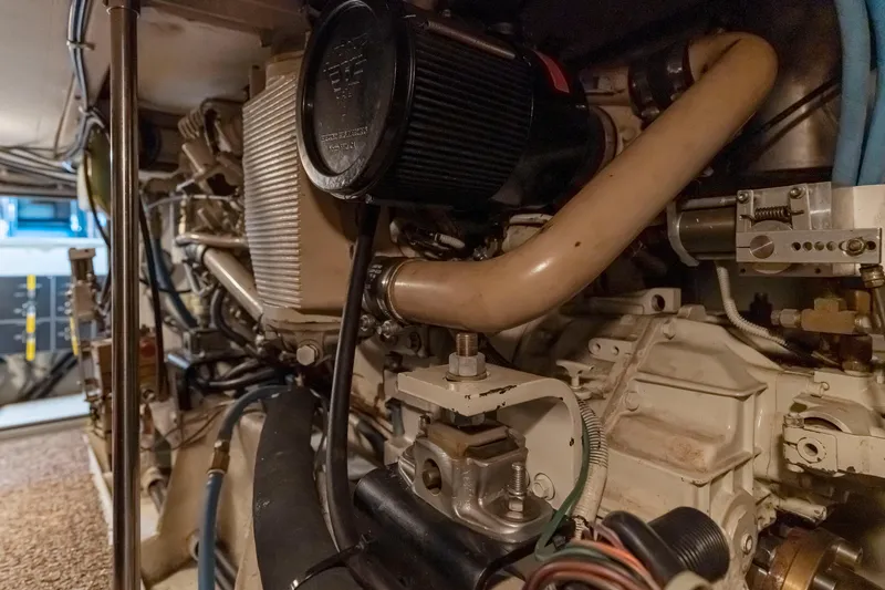 Slide: The Image of Engine room of 1997 Bayliner 4788 Pilot House Motoryacht, showcasing mechanical components. - 46