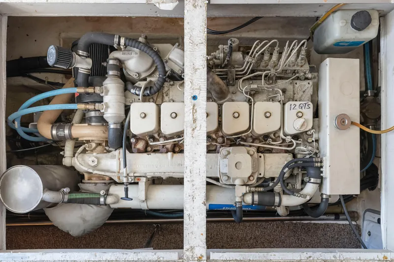 Slide: The Image of Engine compartment of a 1997 Bayliner 4788 Pilot House Motoryacht, showcasing detailed mechanical components. - 48