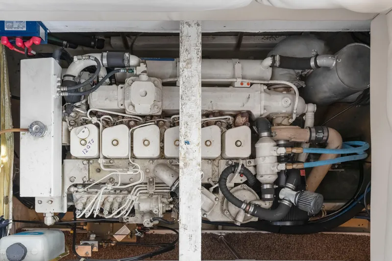 Slide: The Image of Engine compartment of a 1997 Bayliner 4788 Pilot House Motoryacht, showcasing detailed components. - 49