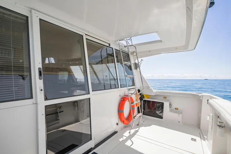 Slide: The Image of 1997 Bayliner 4788 Pilot House Motoryacht deck with ocean view and safety equipment. - 5