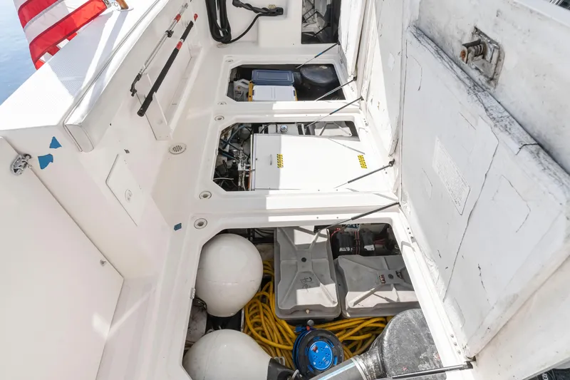 Slide: The Image of 1997 Bayliner 4788 Pilot House Motoryacht engine compartment with storage and equipment. - 7