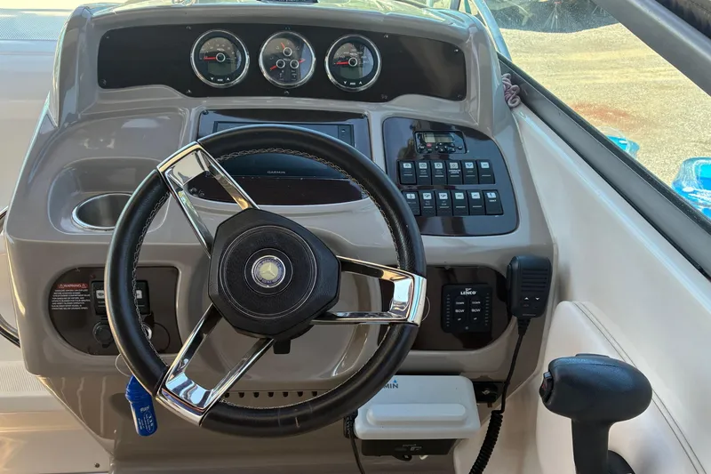 Slide: The Image of Steering console of 2018 Chaparral 270 Signature boat with gauges and controls. - 12