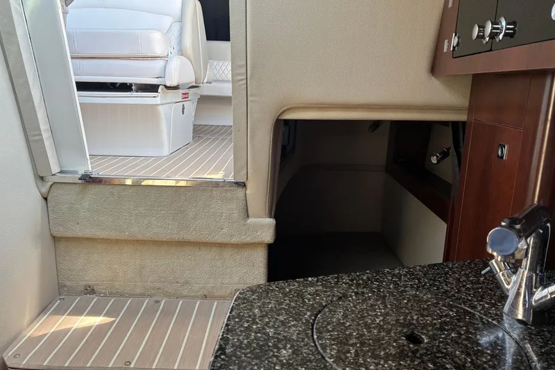 Slide: The Image of Interior of 2018 Chaparral 270 Signature boat with seating and kitchenette area. - 17