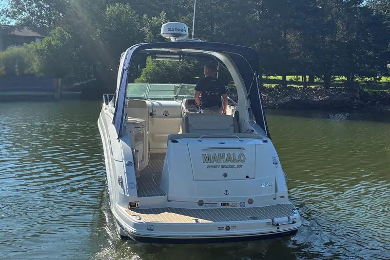 Slide: The Image of 2018 Chaparral 270 Signature boat on water, rear view with "MAHALO" text. - 3