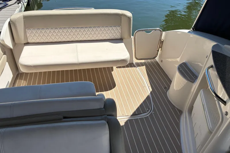 Slide: The Image of 2018 Chaparral 270 Signature boat interior with beige seating and striped flooring. - 6