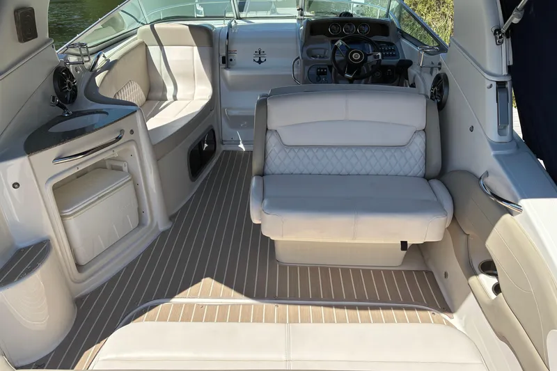 Slide: The Image of 2018 Chaparral 270 Signature boat interior with seating, helm, and kitchenette. - 7