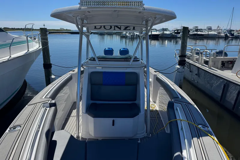 Slide: The Image of 2008 Donzi 32 ZF Open boat docked at marina, clear sky, calm water. - 6