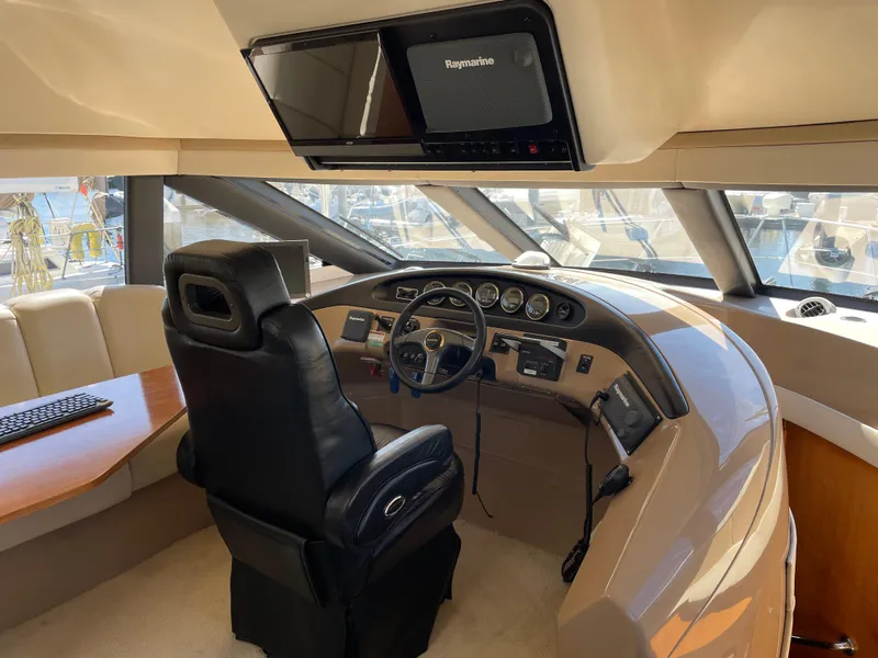 Slide: The Image of Pilothouse interior of 2000 Carver 530 Voyager, featuring steering wheel and navigation equipment. - 11