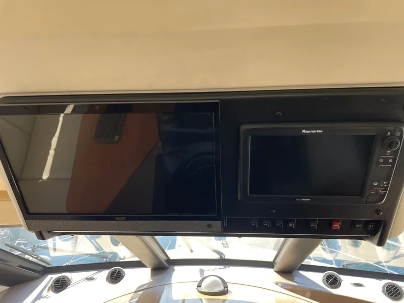 Slide: The Image of Control panel of 2000 Carver 530 Voyager Pilothouse with navigation screens. - 16