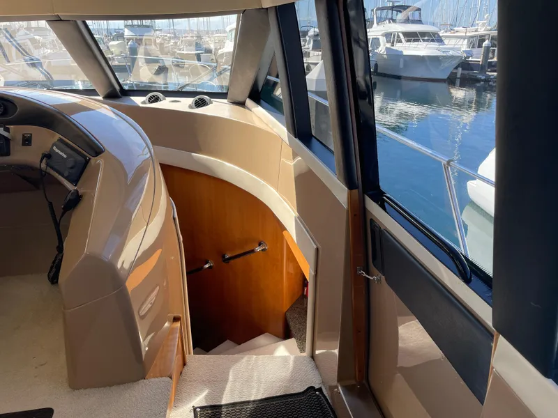 Slide: The Image of Interior view of 2000 Carver 530 Voyager Pilothouse, showcasing helm and staircase. - 18