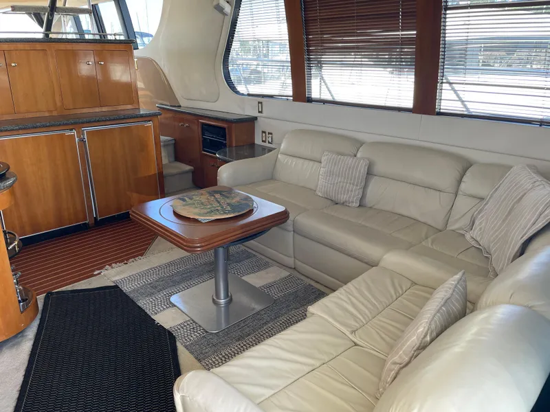 Slide: The Image of Interior of 2000 Carver 530 Voyager Pilothouse with leather seating and wooden cabinetry. - 2