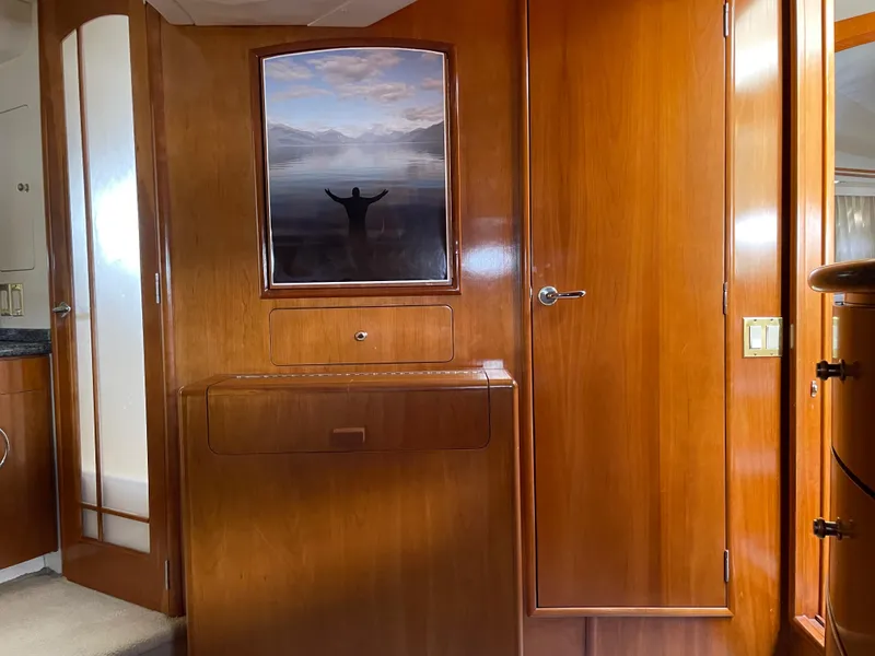 Slide: The Image of Interior of 2000 Carver 530 Voyager Pilothouse with wood paneling and framed artwork. - 23
