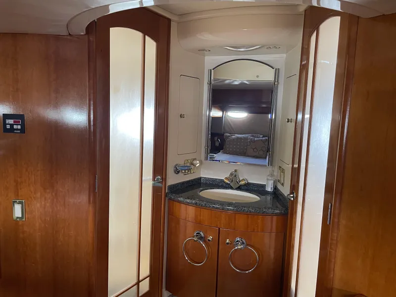 Slide: The Image of Interior of 2000 Carver 530 Voyager Pilothouse with wooden cabinetry and bathroom sink. - 27