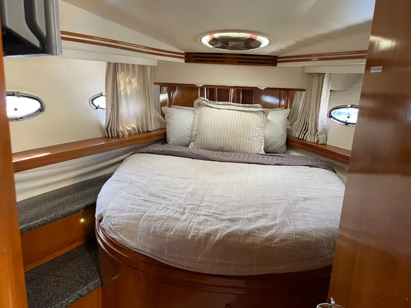 Slide: The Image of Luxurious bedroom interior of 2000 Carver 530 Voyager Pilothouse yacht with elegant wood finish. - 32