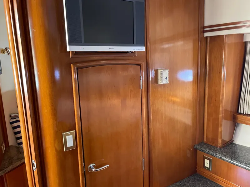 Slide: The Image of Interior of 2000 Carver 530 Voyager Pilothouse with wood paneling and mounted TV. - 34