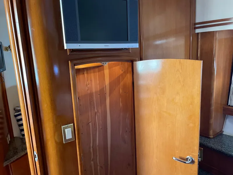 Slide: The Image of Interior of 2000 Carver 530 Voyager Pilothouse with wooden cabinetry and mounted TV. - 35