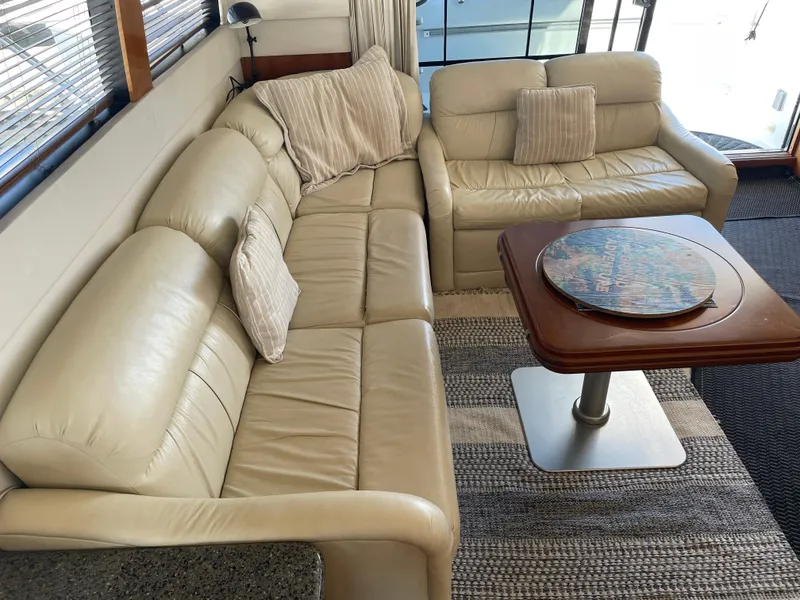 Slide: The Image of Luxurious interior of 2000 Carver 530 Voyager Pilothouse with beige leather seating. - 4