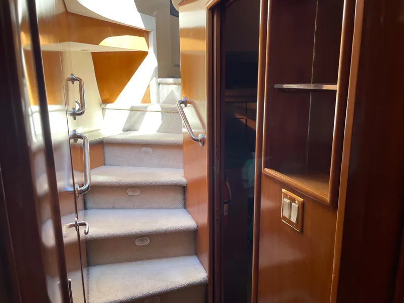 Slide: The Image of Interior stairs of 2000 Carver 530 Voyager Pilothouse yacht with wooden finish. - 41