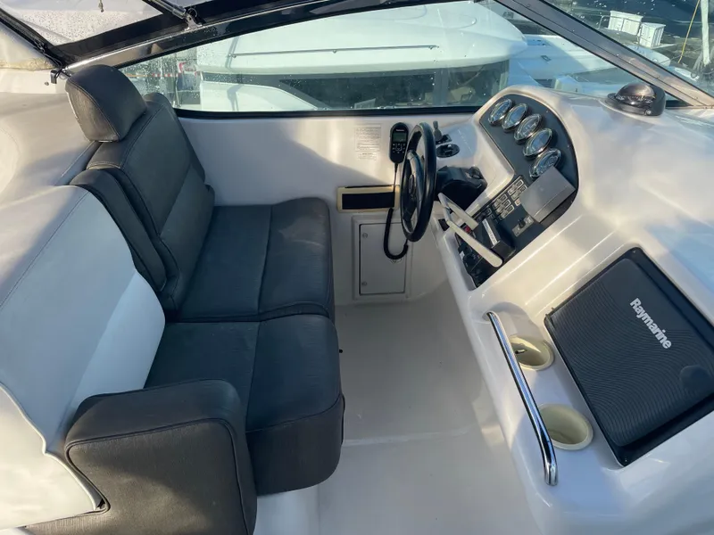 Slide: The Image of 2000 Carver 530 Voyager Pilothouse interior with steering wheel and navigation equipment. - 44