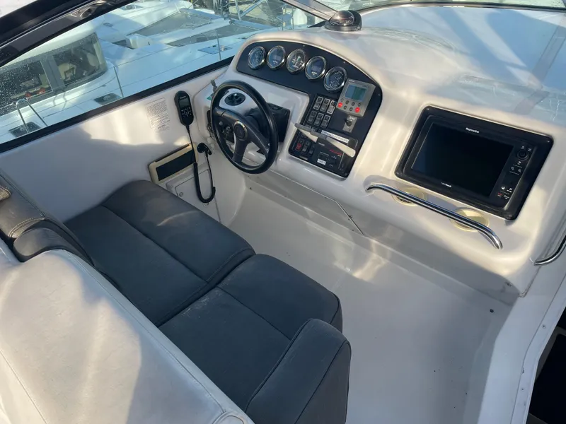 Slide: The Image of 2000 Carver 530 Voyager Pilothouse helm with steering wheel, gauges, and navigation equipment. - 45