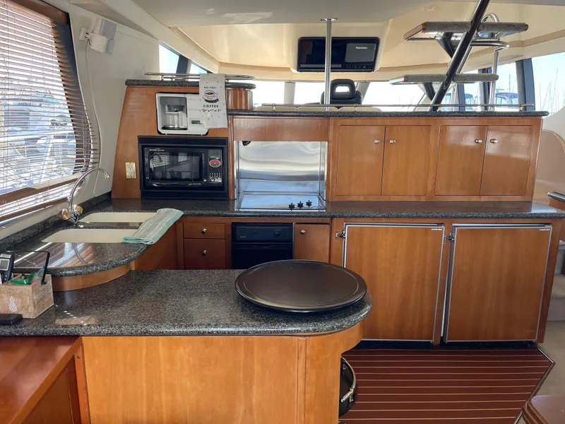 Slide: The Image of Interior of 2000 Carver 530 Voyager Pilothouse with modern kitchen amenities. - 6