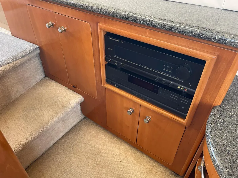 Slide: The Image of Interior of 2000 Carver 530 Voyager Pilothouse with wooden cabinetry and audio system. - 10