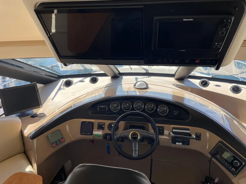Slide: The Image of Pilothouse interior of 2000 Carver 530 Voyager, featuring steering wheel and navigation equipment. - 13