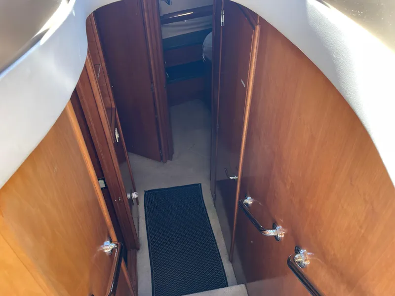 Slide: The Image of Interior hallway of 2000 Carver 530 Voyager Pilothouse yacht with wooden paneling. - 19