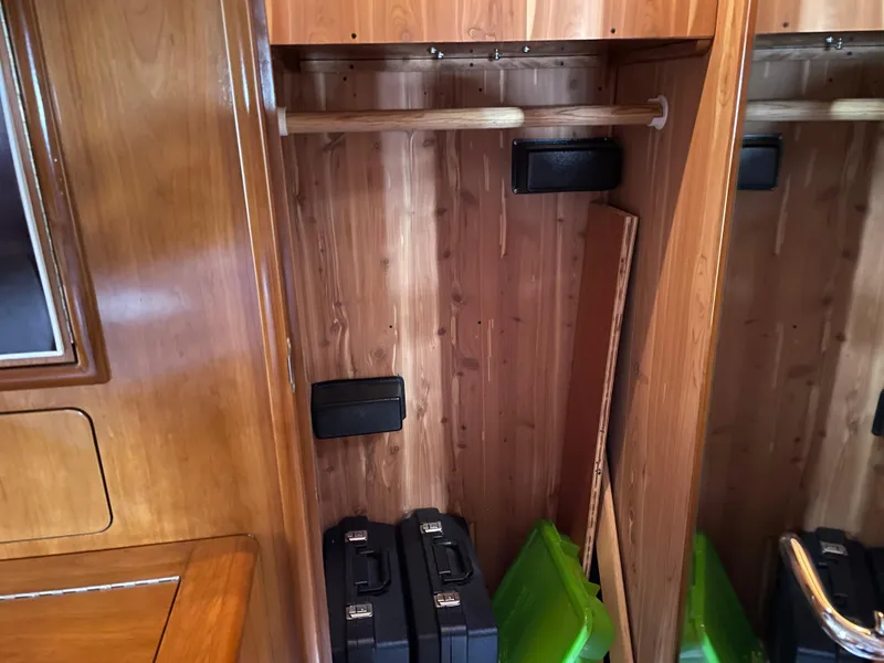 Slide: The Image of Wooden closet interior on 2000 Carver 530 Voyager Pilothouse yacht, with storage items. - 25