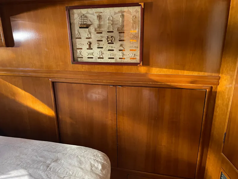 Slide: The Image of Interior of 2000 Carver 530 Voyager Pilothouse with wood paneling and framed nautical artwork. - 30