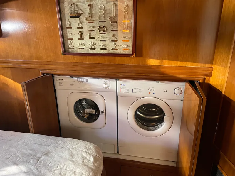 Slide: The Image of Laundry area with washer and dryer in 2000 Carver 530 Voyager Pilothouse yacht. - 31