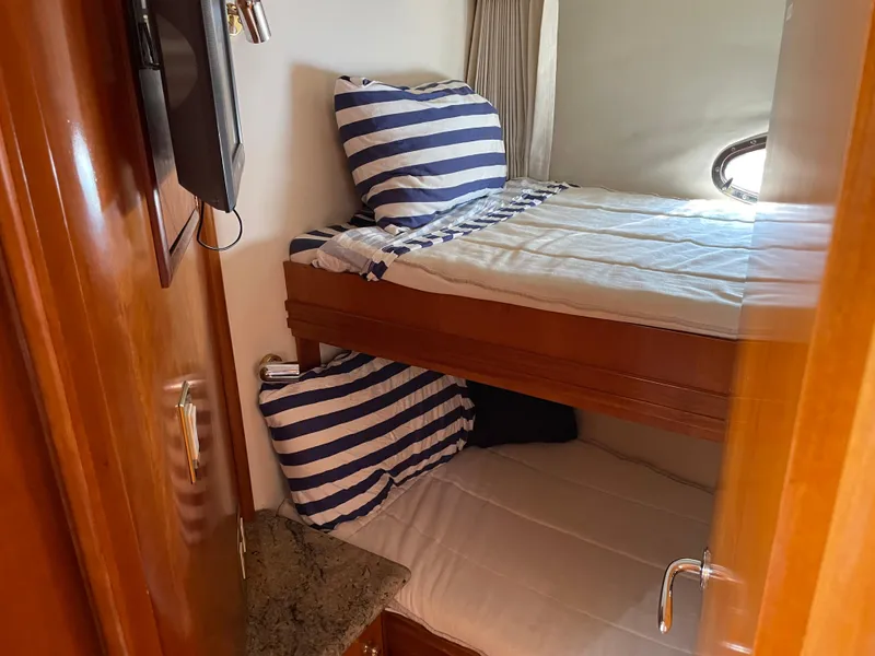 Slide: The Image of Bunk beds in 2000 Carver 530 Voyager Pilothouse cabin with striped bedding. - 37