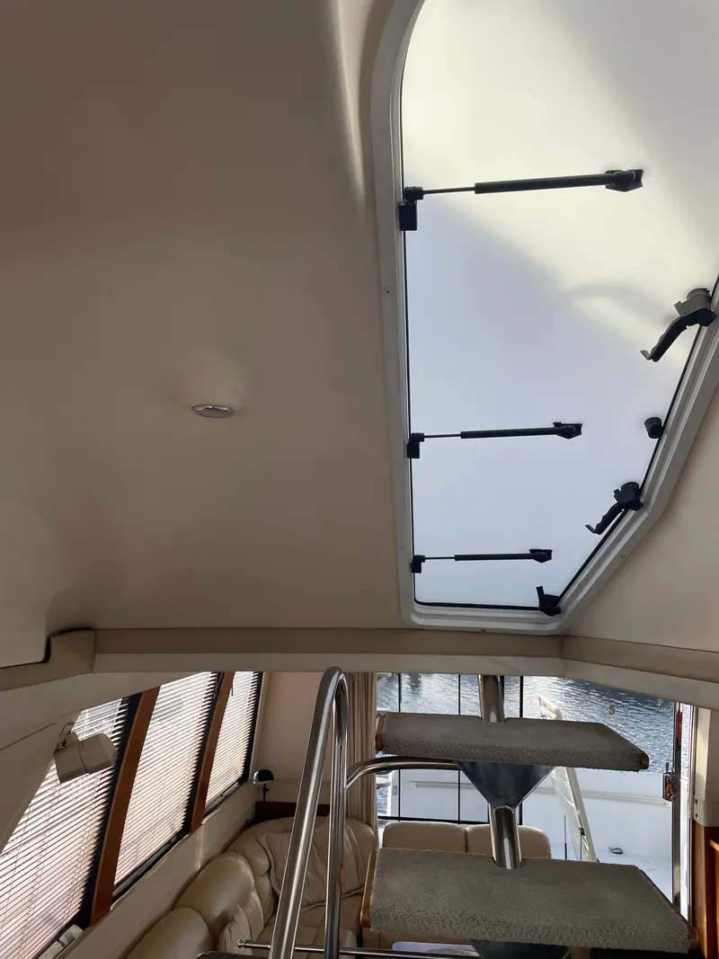 Slide: The Image of Interior view of 2000 Carver 530 Voyager Pilothouse with skylight and seating area. - 43