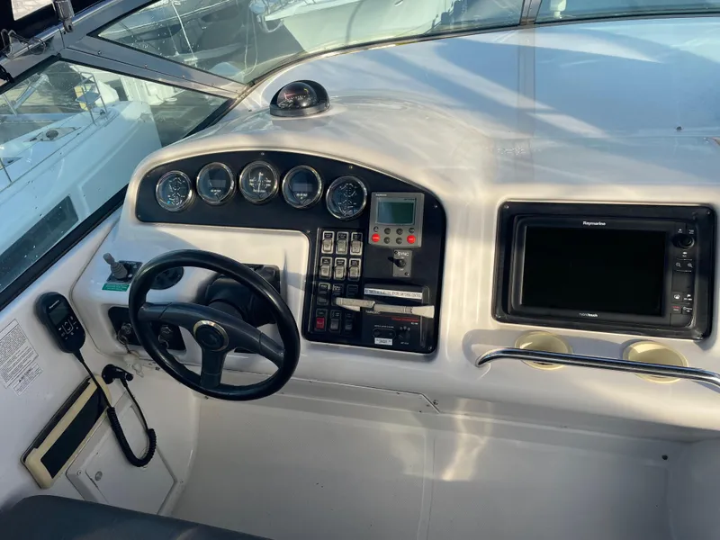Slide: The Image of 2000 Carver 530 Voyager Pilothouse helm with steering wheel and navigation instruments. - 46