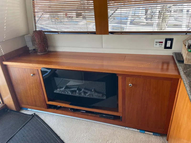 Slide: The Image of Interior of 2000 Carver 530 Voyager Pilothouse with wooden cabinetry and built-in fireplace. - 5