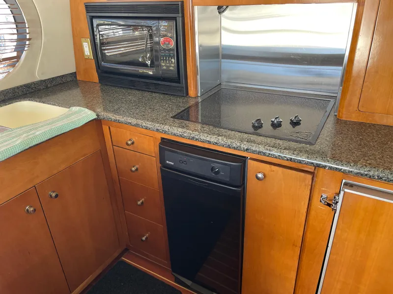 Slide: The Image of Kitchen area of 2000 Carver 530 Voyager Pilothouse with stove, microwave, and dishwasher. - 8