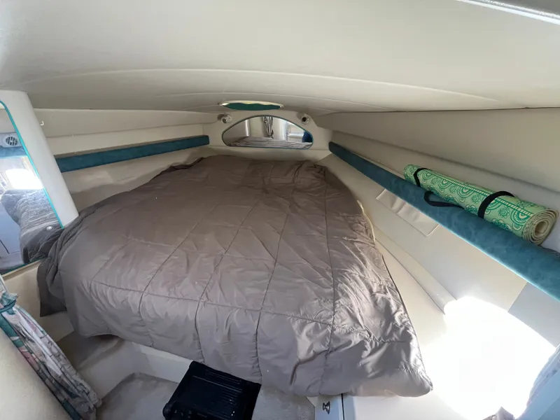 Slide: The Image of 1996 Cruisers Yachts 3375 cabin interior with bed and storage space. - 10