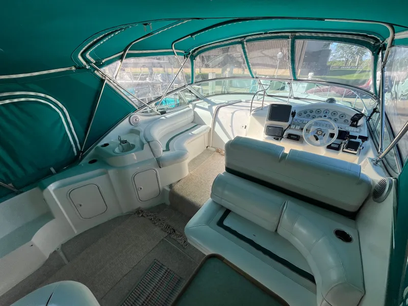 Slide: The Image of 1996 Cruisers Yachts 3375 interior with helm, seating, and green canopy. - 4