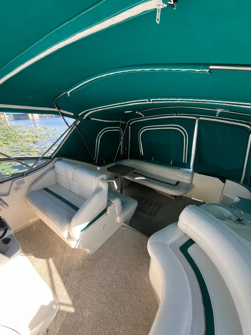 Slide: The Image of 1996 Cruisers Yachts 3375 interior with green canopy and white seating. - 6